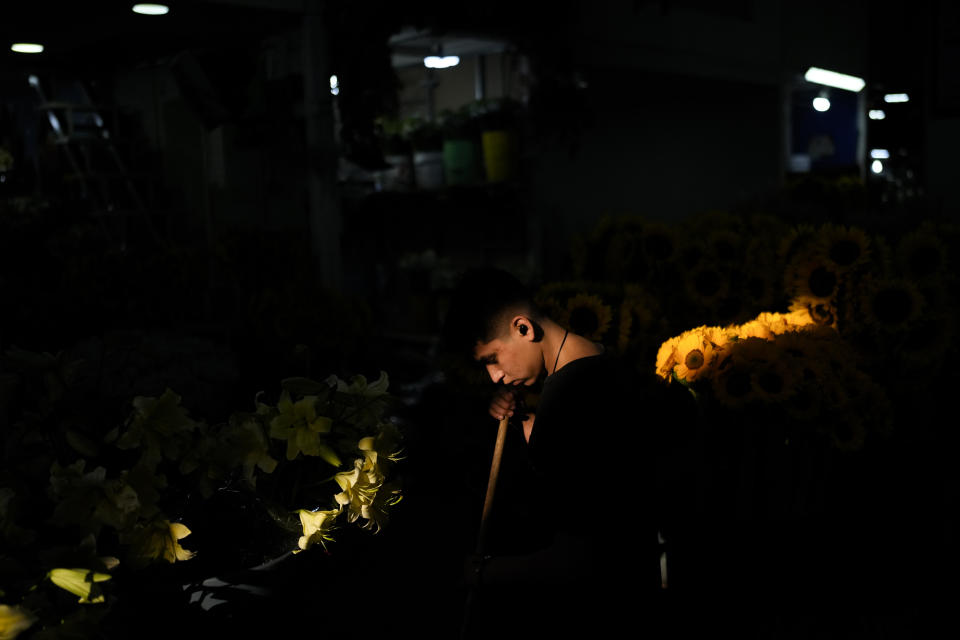 A vendor sweeps his flowers shop at the Jamaica market in Mexico City, Wednesday, May 29, 2024. Mexico's general election is set for June 2. (AP Photo/Matias Delacroix)