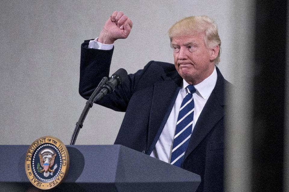 President Donald Trump holds up a fist after speaking at the Central Intelligence Agency in Langley, Va., Saturday, Jan. 21, 2017. (AP Photo/Andrew Harnik)