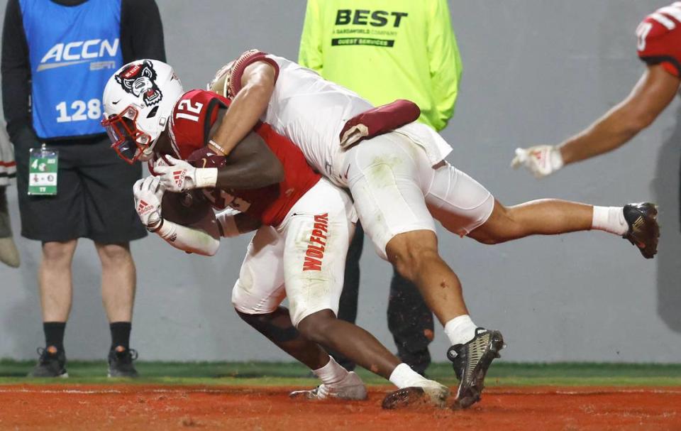N.C. State defensive back Devan Boykin (12) intercepts the ball intended for Florida State wide receiver Mycah Pittman (4) during the second half of N.C. State’s 19-17 victory over Florida State at Carter-Finley Stadium in Raleigh, N.C., Saturday, Oct. 8, 2022.