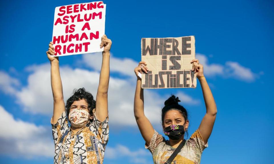 Two protesters holding up placards