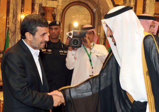 Saudi's Crown Prince Salman Ibn Abdul Aziz greeting Iranian President Mahmoud Ahmadinejad (L) upon his arrival in the Saudi city of Mecca to attend an Islamic summit. The Islamic summit meeting announced the suspension of Syria from the 57-member Organisation of Islamic Cooperation (OIC)