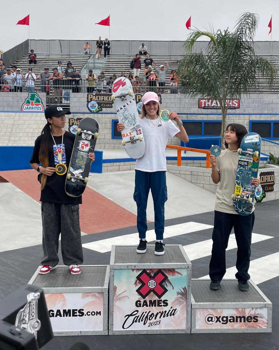 Chloe Covell is awarded her first X Games gold medal after winning the Women's Skateboarding Street competition Saturday at the Ventura County Fairgrounds. Liz Akama (left) won silver. Olympic champion Momiji Nishiya earned bronze.