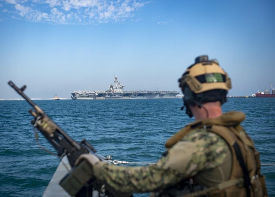 A Sailor assigned to a Mark VI Patrol Boat attached to Commander, Task Force 56 participates in a high value asset (HVA) escort transit of the Nimitz-class aircraft carrier USS Abraham Lincoln (CVN 72) after a port visit in Manama, Bahrain, Dec. 2