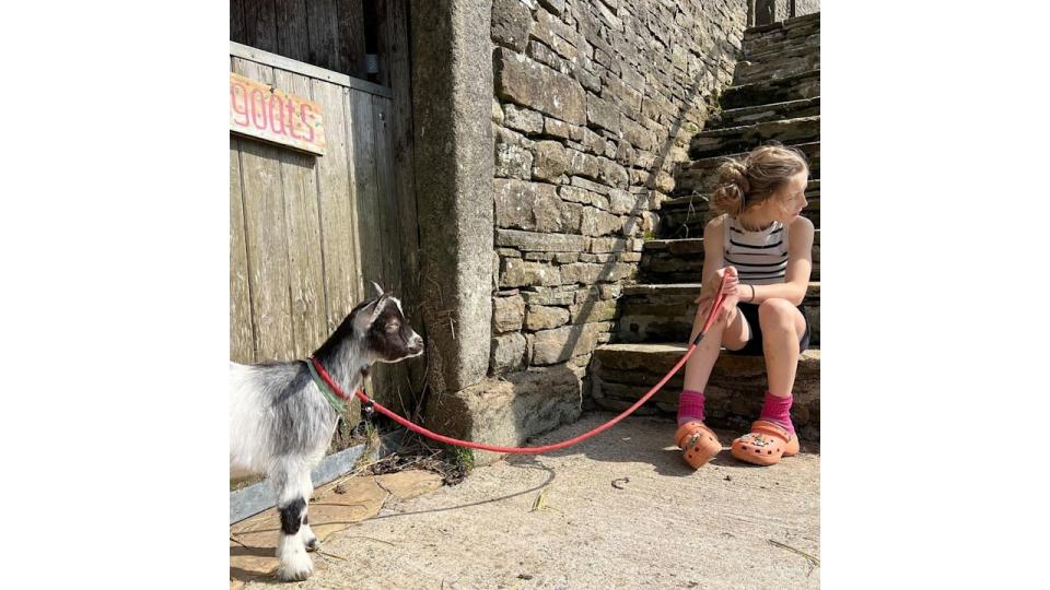 Amanda Owen's daughter with a goat