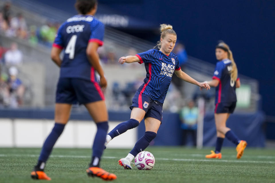 FILE - OL Reign defender Emily Sonnett (2) moves the ball against the Portland Thorns during the first half of an NWSL soccer match, Saturday, June 3, 2023, in Seattle. National Women's Soccer League champion Gotham FC has signed U.S. national team players and World Cup champions Rose Lavelle and Emily Sonnett through 2026, the team announced Thursday, Jan. 4, 2024. Lavelle and Sonnett, both midfielders, played for OL Reign last season and were free agents.(AP Photo/Lindsey Wasson, File)