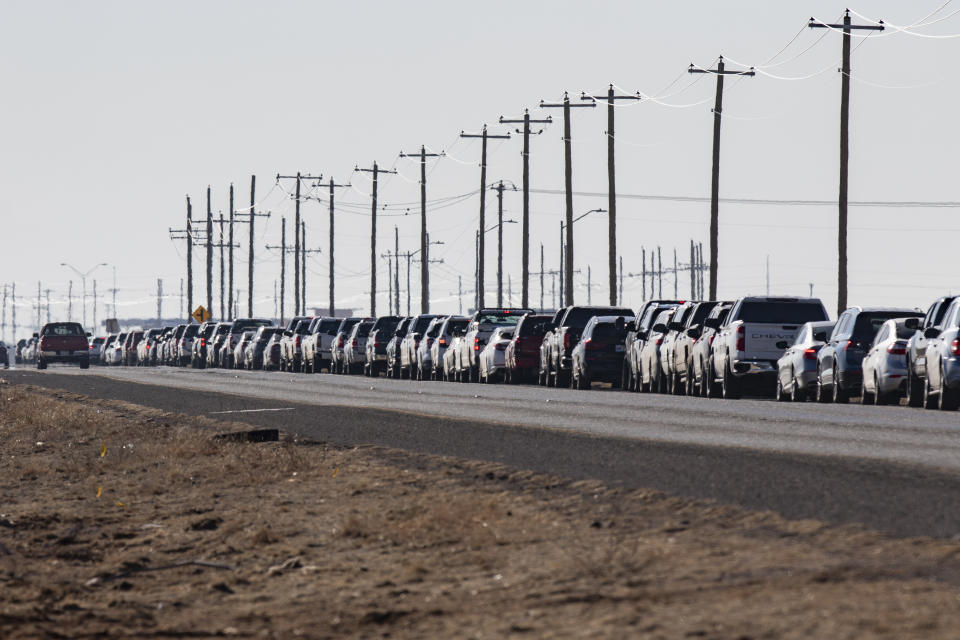 Motorists wait in line for the second dose of the Pfizer COVID-19 vaccine on Texas Loop 338 during the first day of the second dose vaccinations at the Ratliff Stadium Mass Vaccination Site on Tuesday, March 2, 2021 in Odessa, Texas. (Jacob Ford/Odessa American via AP)