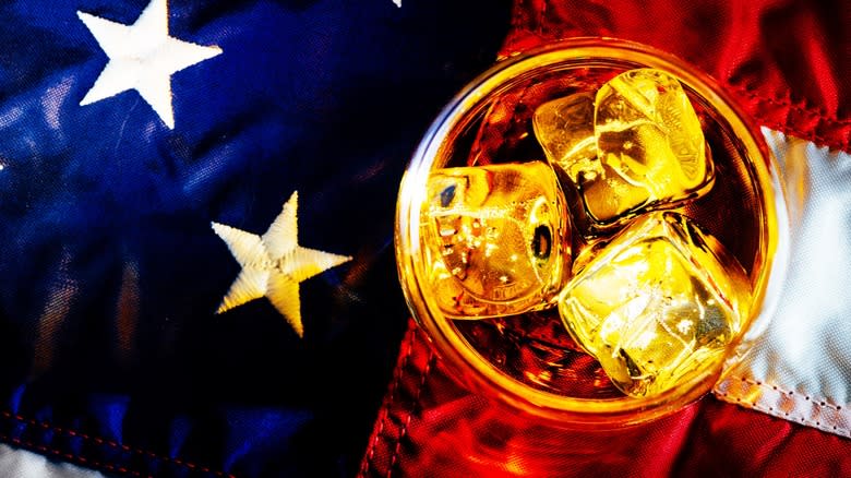 Top-down view of a glass of bourbon on an American flag