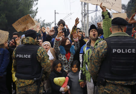 Migrants stage demonstration in front of Macedonian police, as they wait to cross the border from Greece into Macedonia, near Gevgelija, Macedonia November 21, 2015. REUTERS/Ognen Teofilovski