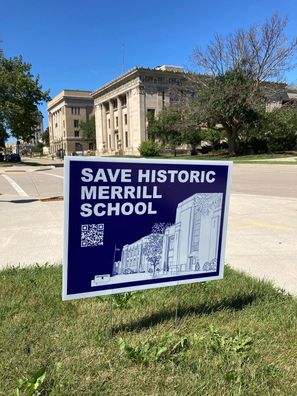 A sign supporting efforts to preserve Merrill School is shown Aug. 30, 2022, on Washington Avenue in downtown Oshkosh. A group of residents is leading an effort to preserve the building after Oshkosh Area School District staff unveiled plans for the property that didn't specify what will happen to the school.