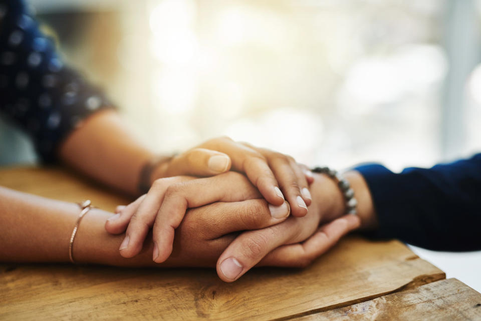 A couple holds hands