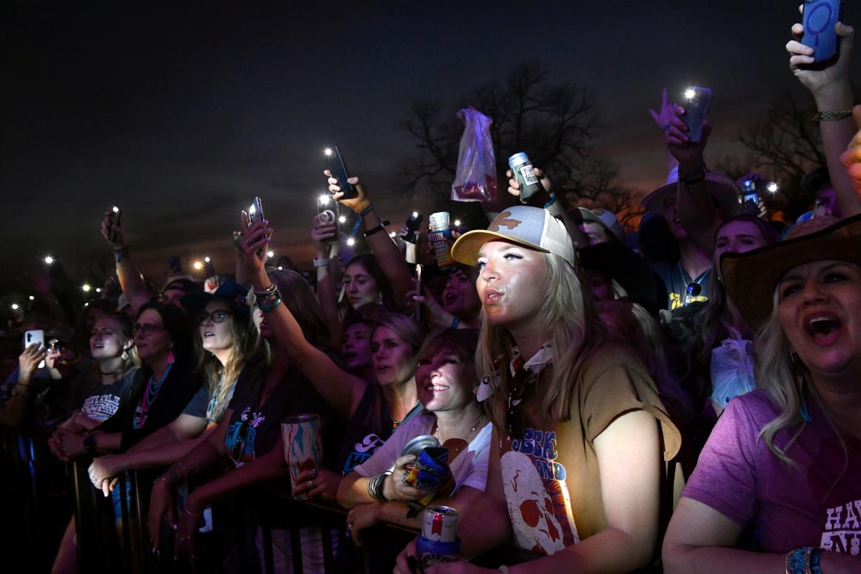 Fans wave the flashlights on their cellphones during Kevin Fowler’s performance at Outlaws & Legends Music Fest April 1, 2023.