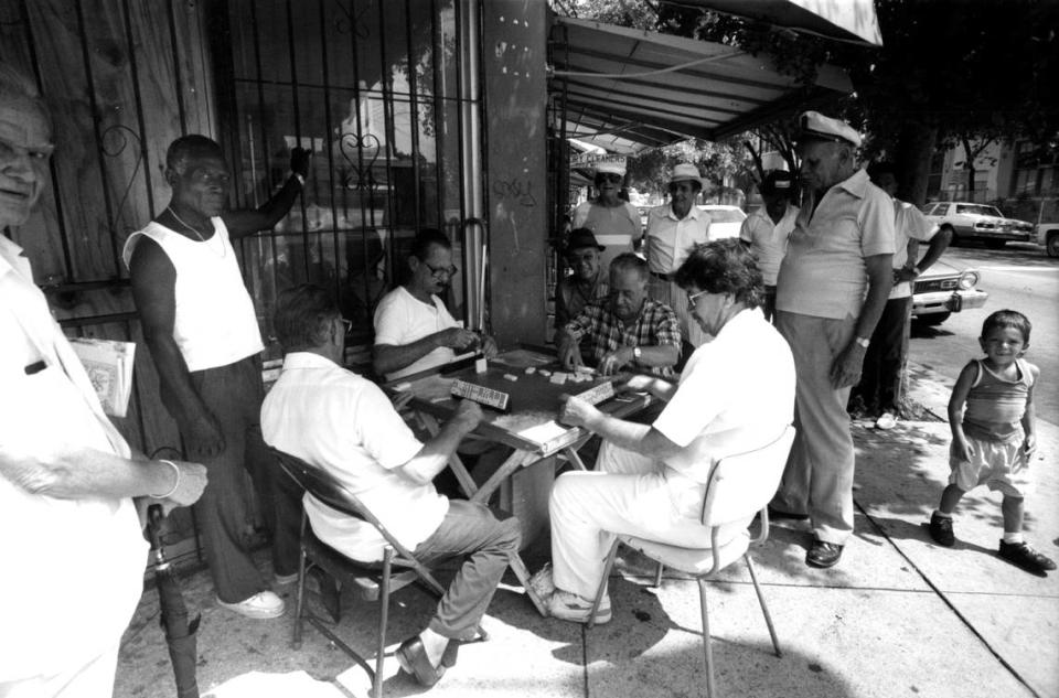 A group of neighbors in Wynwood play dominoes in a corner on Second Avenue. Fernando Yoveral/Miami Herald / 1992