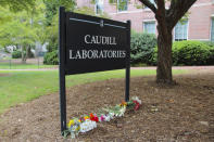 Flowers are seen piled up in front of Caudill Laboratories, Tuesday, Aug. 29, 2023, on the UNC-Chapel Hill campus, where a graduate student fatally shot his faculty advisor this week in Chapel Hill, N.C. (AP Photo/Hannah Schoenbaum)
