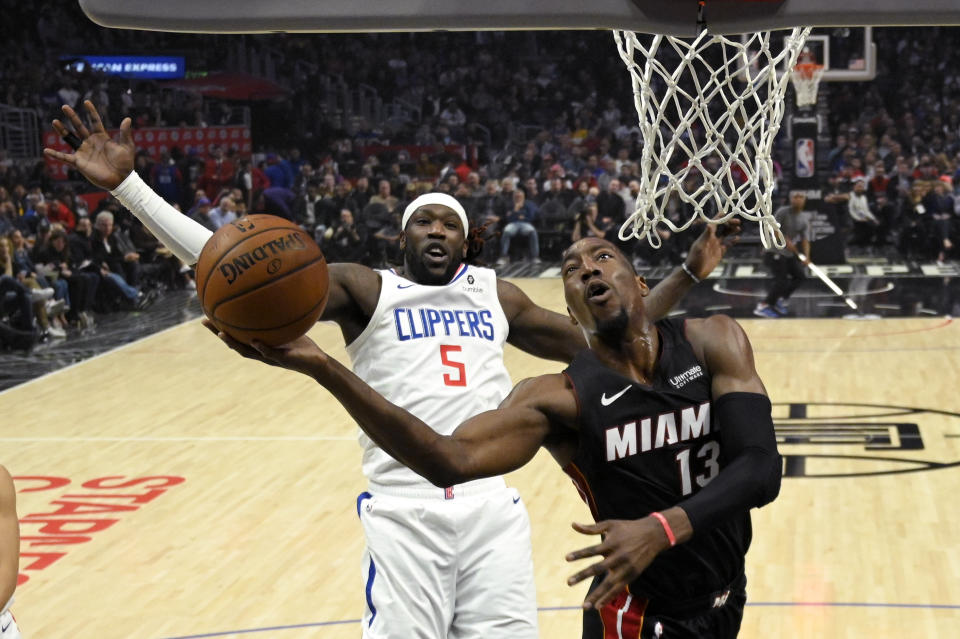 Miami Heat forward Bam Adebayo, right, shoots as Los Angeles Clippers forward Montrezl Harrell defends during the first half of an NBA basketball game Wednesday, Feb. 5, 2020, in Los Angeles. (AP Photo/Mark J. Terrill)