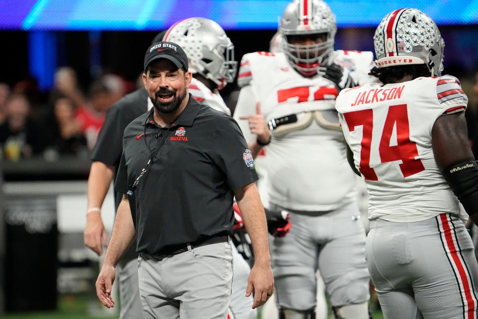 Ohio State Buckeyes head football coach Ryan Day leads his team in warmups prior to the Peach Bowl in the College Football Playoff semifinal, Dec 31, 2022, in Atlanta. Georgia won 42-41.