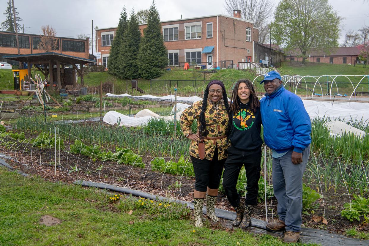 From left, Cleaster Cotton, artist and educator, Chloe Moore, manager of the Southside Community Farm, and Musa Fardan, a founder of the farm, stand next to the growing vegetables in the garden on Livingston Street in Asheville, April 11, 2024.