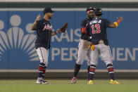 Atlanta Braves left fielder Eddie Rosario, left, center fielder Michael Harris II and right fielder Ronald Acuna Jr. celebrate after a baseball game against the Washington Nationals at Nationals Park, Tuesday, Sept. 27, 2022, in Washington. The Braves won 8-2. (AP Photo/Jess Rapfogel)