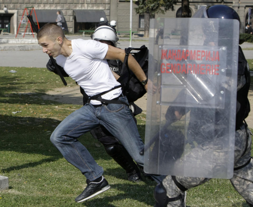 This Oct. 10, 2010 file photo shows a Serbian riot police detaining a man during an anti-gay pride march in Belgrade, Serbia. "The Parade," a black comedy made by a Serbian director, has been the biggest box office hit in the former Yugoslavia in years, even as it challenges both the region's ethnic divide and its deeply rooted homophobia. The movie has drawn more than half a million people since its release in October. It has been equally acclaimed in Serbia, Croatia and Bosnia _ something no local film has managed since the 1990s wars between the ex-Yugoslav republics. (AP Photo/Darko Vojinovic)