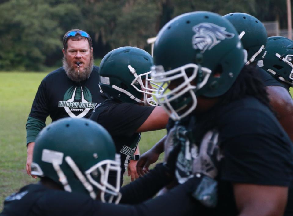 Windsor Forest head coach Jeb Stewart watches as linemen practice at a 2021 workout.