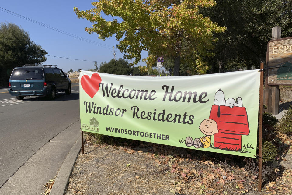 A roadside banner welcomes back residents who were evacuated for several days as firefighters battled the Kincade Fire in Windsor, Calif., Thursday, Oct. 31, 2019. For most of October, fires sprang up across the state, forcing residents to flee homes at all hours as flames indiscriminately burned barns, sheds, mobile homes and multimillion-dollar mansions. (AP Photo/Terry Chea)