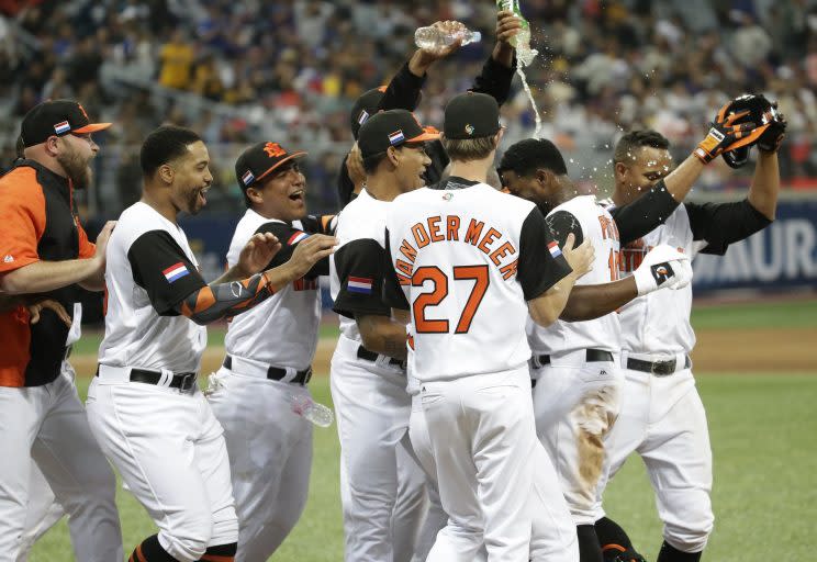 Netherlands's players pour waters to Jurickson Profar, second from right, to celebrate after winning against Taiwan at the first round game of the World Baseball Classic at Gocheok Sky Dome in Seoul, South Korea, Wednesday, March 8, 2017. (AP Photo/Ahn Young-joon).