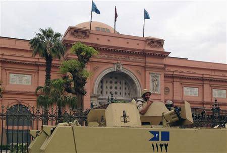 A soldier in a military vehicle keeps guard in front of the Egyptian Museum in Tahrir square in Cairo April 19, 2014. Picture taken April 19, 2014. REUTERS/Asmaa Waguih