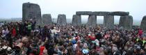 Crowds gather at dawn amongst the stones at Stonehenge in Wiltshire for the Summer Solstice.