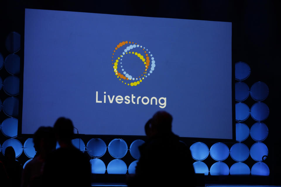 In this Monday, Feb. 3, 2020 photo, guests attend an event where the new logo for Livestrong was unveiled in Austin, Texas. The Livestrong cancer charity is on a mission to reinvent itself. It has survived a dramatic fall in contributions and donations since founder Lance Armstrong's performance-enhancing drug scandal. (AP Photo/Eric Gay)