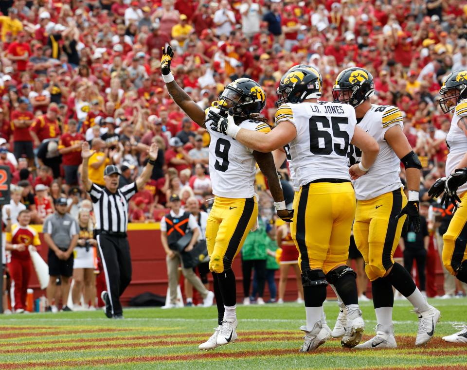 AMES, IA - SEPTEMBER 9: Running back Jaziun Patterson #9 of the Iowa Hawkeyes celebrates with teammates offensive lineman Logan Jones #65, and defensive lineman Logan Lee #85 of the Iowa Hawkeyes after scoring a touchdown in the first half of play against the Iowa State Cyclones at Jack Trice Stadium on September 9, 2023 in Ames, Iowa. (Photo by David Purdy/Getty Images)