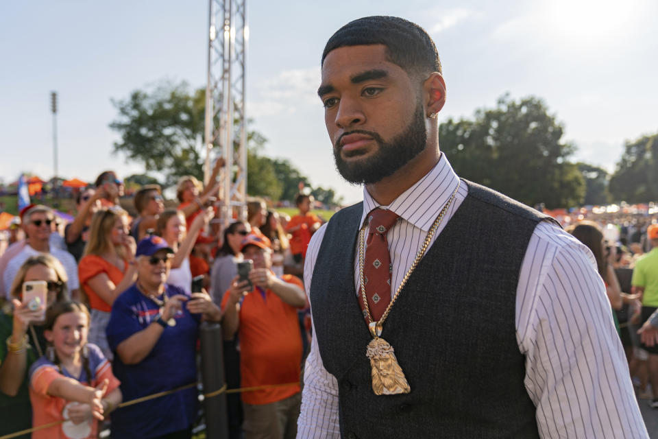 Clemson quarterback DJ Uiagalelei walks into the stadium past fans before the team's NCAA college football game against Louisiana Tech on Saturday, Sept. 17, 2022, in Clemson, S.C. (AP Photo/Jacob Kupferman)