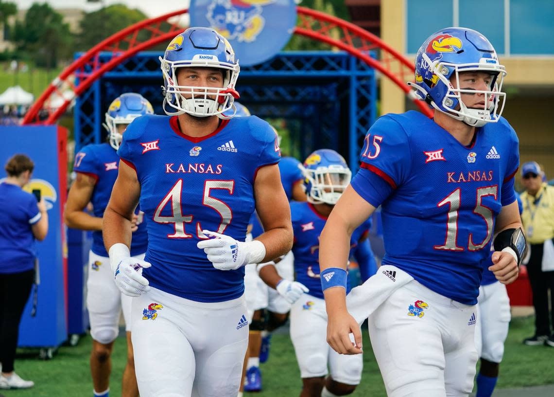 Kansas Jayhawks tight end Trevor Kardell (45) and quarterback Miles Fallin (15) take the field before the game against the South Dakota Coyotes at David Booth Kansas Memorial Stadium on Sept. 3, 2021. Jay Biggerstaff/USA TODAY Sports