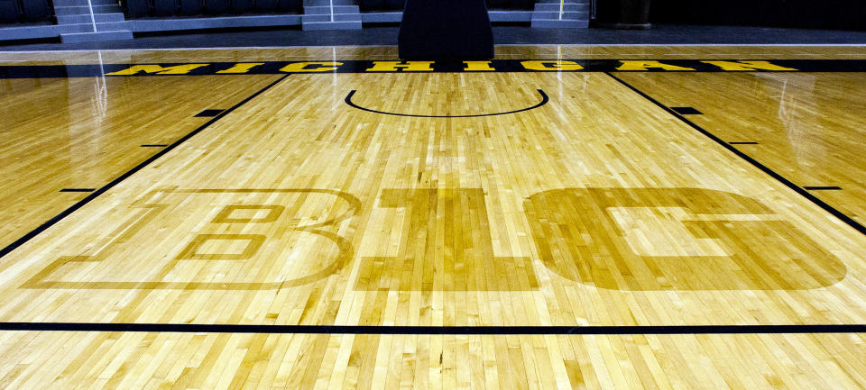 FILE - In this Oct. 11, 2011, file photo, the new Big Ten Conference logo "B1G" is stained into the wood of the newly-renovated Crisler Arena court during NCAA college basketball media day in Ann Arbor, Mich. Southern California and UCLA will play two road games apiece against the Big Ten's easternmost schools while fellow conference newcomers Oregon and Washington will make one cross-country trip each during the 2024-25 men's basketball season. (AP Photo/Tony Ding, File)