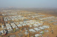 In this aerial photo released by China's Xinhua News Agency, workers build a large centralized quarantine facility capable of holding several thousand people in Shijiazhuang in northern China's Hebei Province, Saturday, Jan. 16, 2021. China on Saturday finished building a 1,500-room hospital for COVID-19 patients in Nangong, south of Beijing in Hebei Province, to fight a surge in infections the government said are harder to contain and that it blamed on infected people or goods from abroad. (Yang Shiyao/Xinhua via AP)