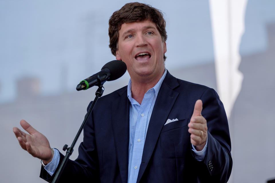 Tucker Carlson speaking at an event