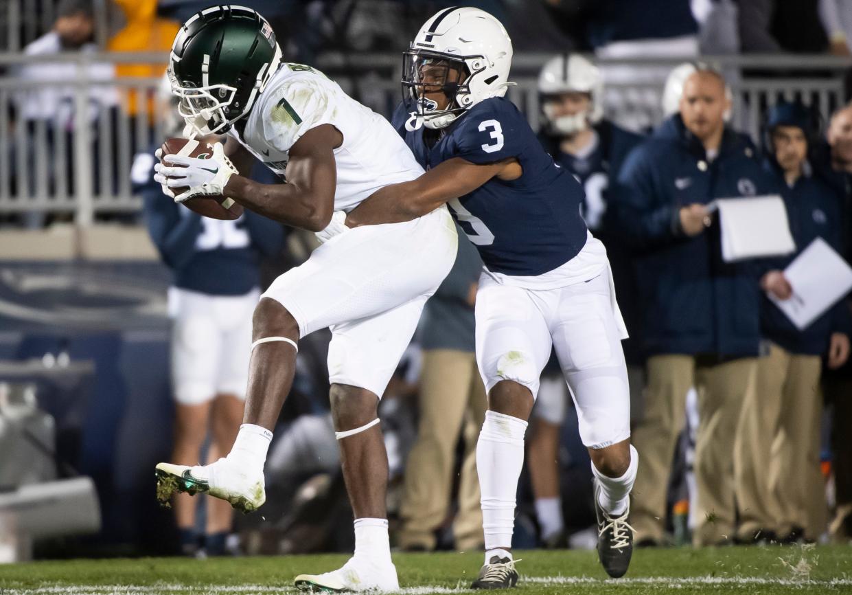 Penn State cornerback Johnny Dixon (3) tackles Michigan State wide receiver Antonio Gates Jr. in the fourth quarter at Beaver Stadium on Saturday, Nov. 26, 2022, in State College. The Nittany Lions won, 35-16.