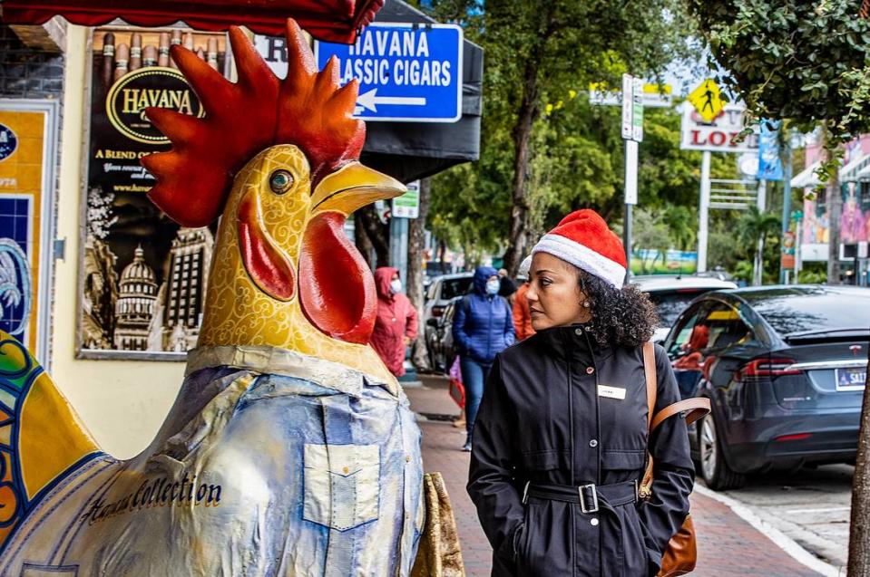 The cold weather on Christmas Day didn’t stop Jenny Perez from taking a walk along Calle Ocho in Little Havana on Sunday, Dec. 25, 2022. South Florida residents may be able to ditch their sweaters this year, according to the National Weather Service in Miami.