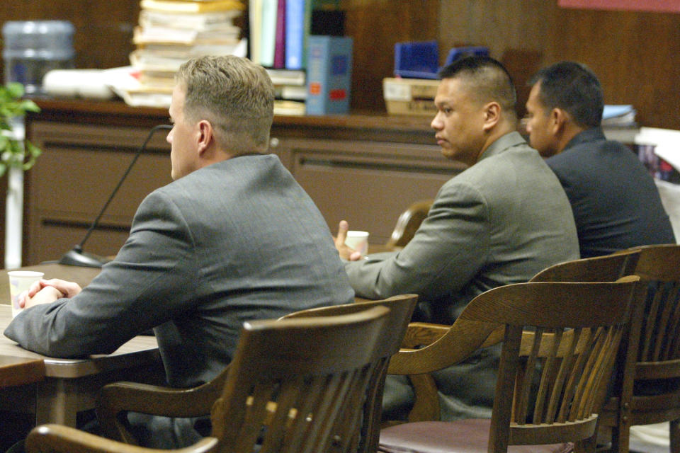 ** CORRECTS TO CORRUPTION TRIAL ** Former Oakland police officers Matthew Hornung, left, Clarence Mabanag and Jude Siapno pause for a moment as they wait for the jury to come back with the verdict in their corruption trial on Tuesday Sept. 30, 2003, at the Alameda County Court House in Oakland, Calif. Jurors found the former officers innocent of eight counts and a judge declared a mistrial on 27 remaining charges on which the jury remained deadlocked.  (AP Photo/Ray Chavez, Pool)