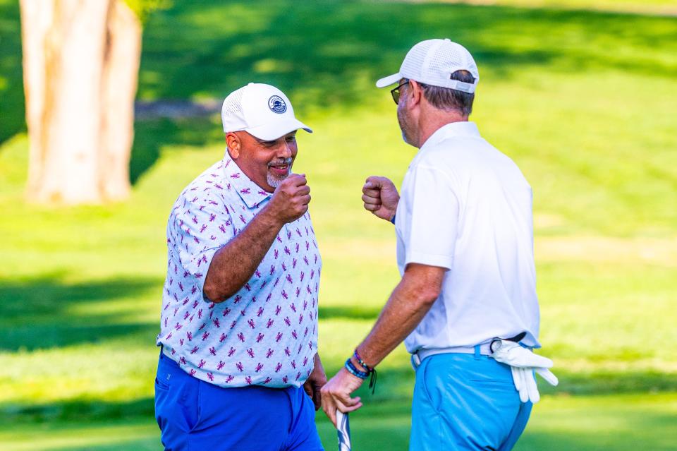 Steve Miranda and Shaun Tavares fist bump after win Hole 12 at the Country Club of New Bedford Fourball Tournament.