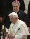 FILE - In his Feb. 14, 2013 file photo, Pope's personal Secretary Mons. Georg Ganswein looks at Pope Benedict XVI during an audience with Roman clergy in the Paul VI Hall at the Vatican. Archbishop Georg Gaenswein told a book presentation Tuesday, Sept. 11, 2018, that the sex abuse scandal that has convulsed the Catholic Church for years is "its own 9/11." (AP Photo/Alessandra Tarantino)