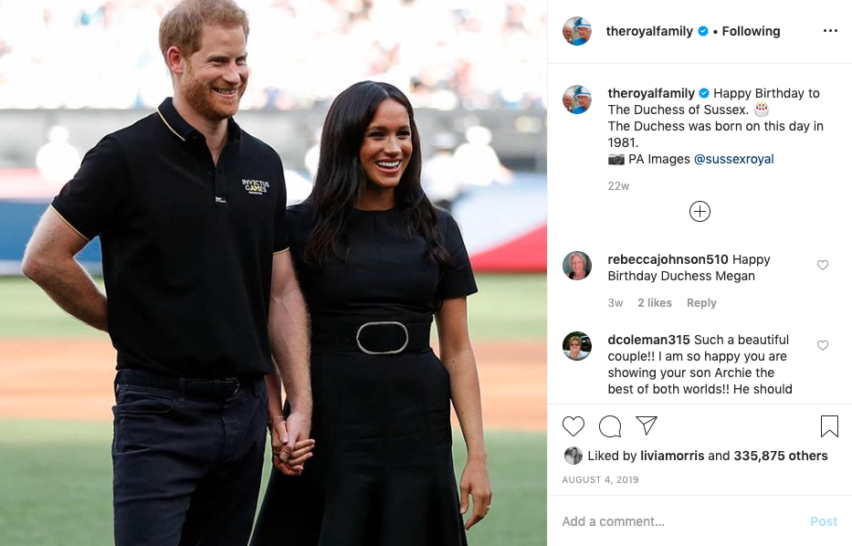 Meghan Markle and Prince Harry holding hands on baseball field