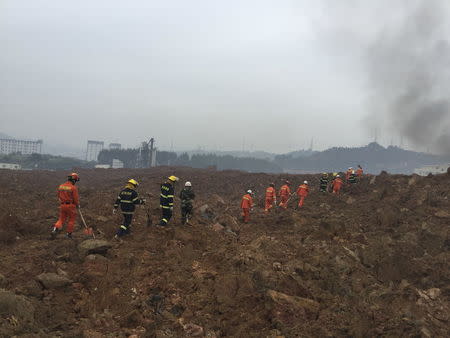 Rescuers search for survivors at the site of a landslide at an industrial park in Shenzhen, Guangdong province, China, December 20, 2015. REUTERS/Stringer