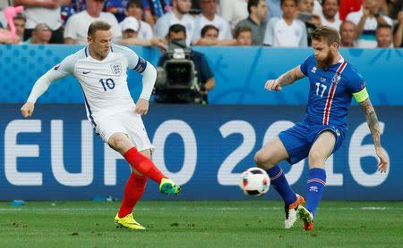 Football Soccer - England v Iceland - EURO 2016 - Round of 16 - Stade de Nice, Nice, France - 27/6/16 England's Wayne Rooney in action with Iceland's Aron Gunnarsson REUTERS/Eric Gaillard Livepic