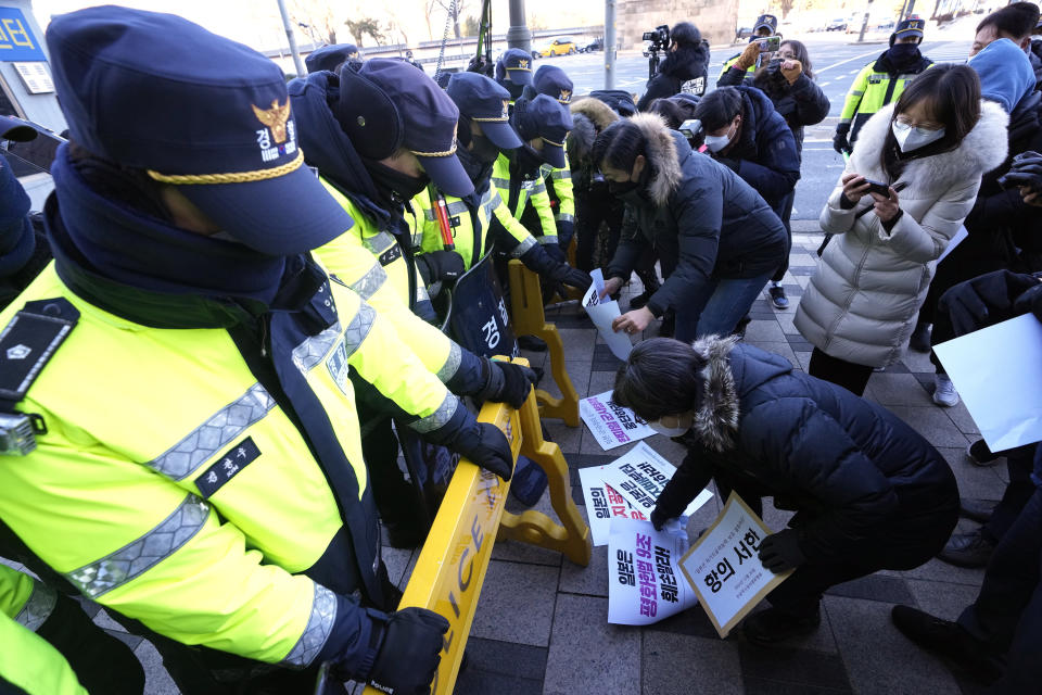 Protesters place banners on the road during a rally opposing Japan's adoption of a new national security strategy near the Japanese Embassy in Seoul, South Korea, Tuesday, Dec. 20, 2022. North Korea threatened Tuesday to take "bold and decisive military steps" against Japan as it slammed Tokyo's adoption of a national security strategy as an attempt to turn the country into an aggressive military power. The banners read "Stop military cooperation between South Korea, the U.S. and Japan military alliance." (AP Photo/Ahn Young-joon)