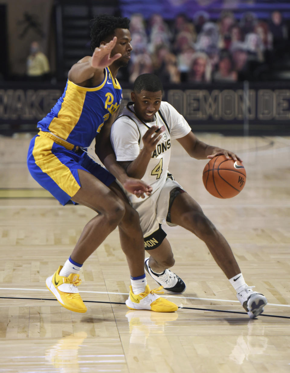 Wake Forest's Daivien Williamson drives the lane against Pittsburgh's Femi Odukale (2) during an NCAA college basketball game Saturday, Jan. 23, 2021, in Winston-Salem, N.C. (Walt Unks/The Winston-Salem Journal via AP)