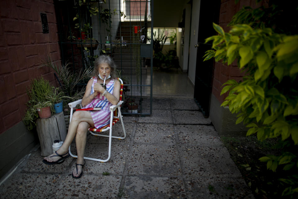 Carmela Corleto drinks mate outside her home where she lives alone and waits for her turn for the COVID-19 vaccine in Burzaco, Argentina, Thursday, Feb. 25, 2021. Corleto, who said that the vaccine is like the light at the end of the tunnel in Ernesto Sabato's book titled “The tunnel,” got her first shot of the AstraZeneca vaccine on April 23, 2021, (AP Photo/Natacha Pisarenko)