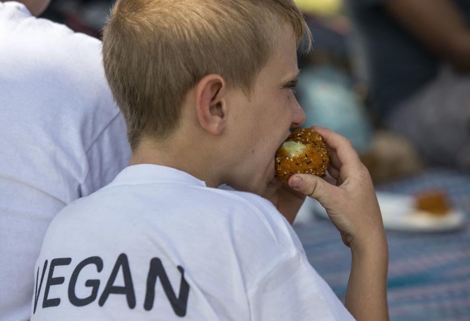 A boy eats a vegan pepper during the Vegan Fest fair in the Israeli city of Ramat Gan near Tel Aviv in October 2014. (Photo: Jack Guez/AFP/Getty Images)