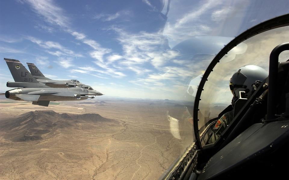 F-16 Fighting Falcons from the US Air Force's 21st Fighter Squadron fly in formation over southern Arizona, July 3, 2002