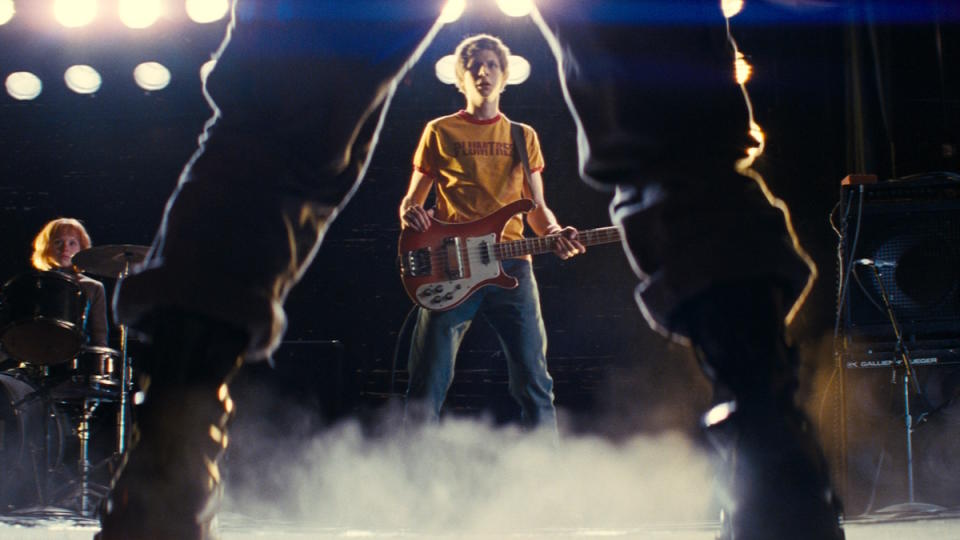 Scott Pilgrim stands on stage challenged by an evil ex-boyfriend in Scott Pilgrim vs. The World