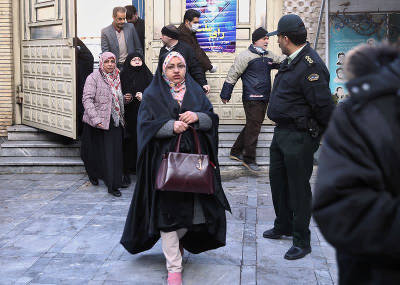 Iranian arrive to vote at a polling station during parliamentary elections in Tehran