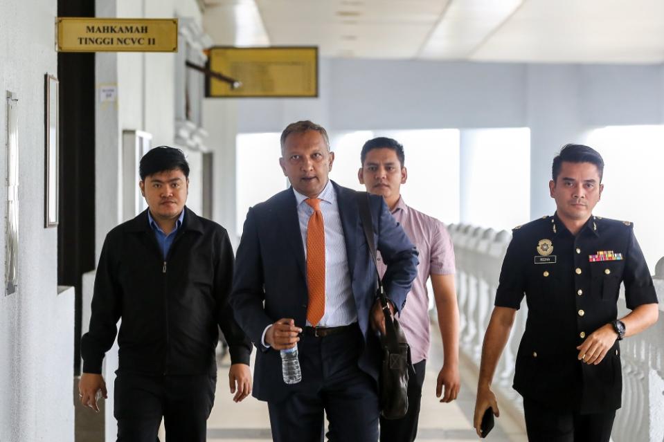 Former BSI banker Kevin Michael Swampillai (centre) is pictured at the Kuala Lumpur High Court Complex March 1, 2023. — Picture by Yusof Mat Isa